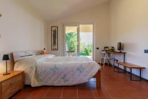 a bedroom with a bed and a table and a window at I 7 MELI in Sarzana