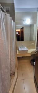 a bathroom with a sink and a shower curtain at Hotel Bertiami in Mar del Plata