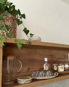 a wooden shelf with glasses and a bottle on it at Seoski turizam Žigale 
