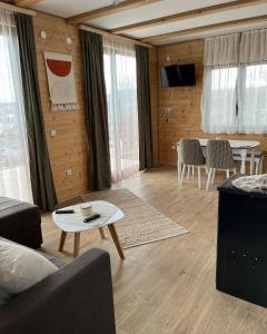 a living room with a couch and a table at Seoski turizam Domaćinstvo Tošanić in Žigale