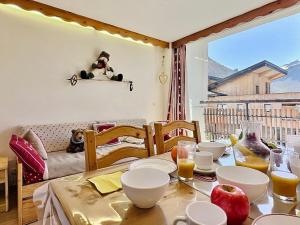 a dining room table with food and orange juice on it at Studio Tignes, 1 pièce, 4 personnes - FR-1-411-480 in Tignes