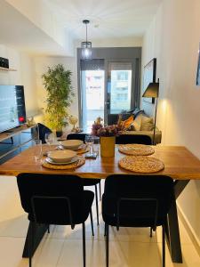 a table in a living room with a dining room at NEW 2BD APRT with SHARED ROOFTOP POOL E2 in Athens