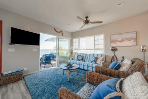 a living room with a couch and a tv at Bayfront Dream - Bay Views, Rooftop Patio, & Garage! in San Diego