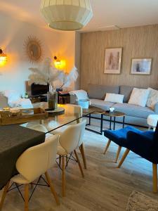 a living room with a couch and a table at Chalet de 3 chambres a Le Devoluy a 200 m des pistes avec piscine partagee sauna et balcon in Le Dévoluy
