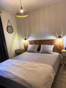 a bedroom with a large white bed with two pillows at Chalet de 3 chambres a Le Devoluy a 200 m des pistes avec piscine partagee sauna et balcon in Le Dévoluy