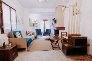 a living room with a couch and chairs at Villa Andromeda Pelion in Portaria