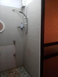 a bathroom with a shower with a glass door at 2 BD, 2BR Condo Rental,Toril in Davao City