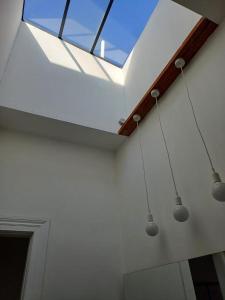 a skylight in a room with three lights at Apartamentos Cerro Alegre in Valparaíso