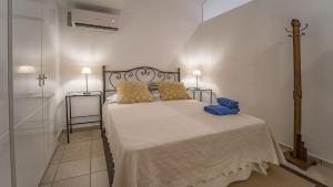 a bedroom with a large bed with yellow pillows at Cap Sa Sal 160 Begur in Begur