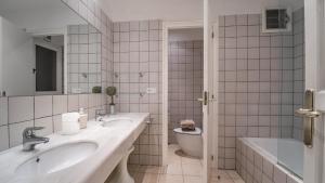 a bathroom with two sinks and a tub and a toilet at Cap Sa Sal 160 Begur in Begur +28 photos
