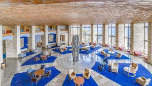 a large room with tables and chairs and windows at Cap Sa Sal 160 Begur in Begur