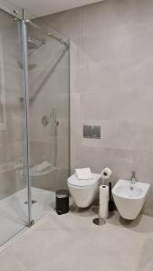 uma casa de banho com um chuveiro, um WC e um lavatório. em Up Sal em Aveiro