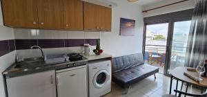 a kitchen with a sink and a washing machine at Primordial Apartment in Rhodes Town