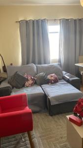 a living room with a couch and a window at Apartamento Peruíbe com vista para o mar in Peruíbe