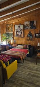 a bedroom with a bed in a room with wooden walls at Casa Tongoy Península in Coquimbo