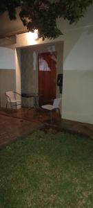 a living room with a table and a chair at DeLutz Overnight Room 3 in Polokwane