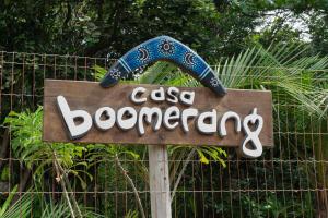 a sign for a casino boomerang in front of a fence at Casa Boomerang in Marau