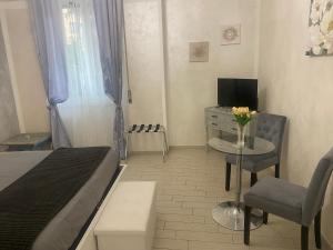 a bedroom with a bed and a desk with a television at Few Steps from Vatican City in Rome