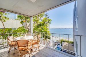a balcony with a table and chairs and a view of the beach at Bayfront Paradise - Flexible 30 Day plus w Amazing Bay View and Pool in San Diego
