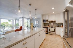 a kitchen with white cabinets and a large counter top at Bayfront Paradise - Flexible 30 Day plus w Amazing Bay View and Pool in San Diego