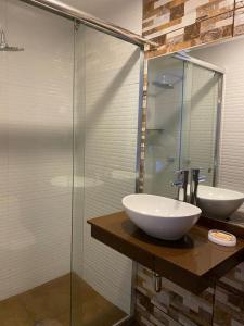 a bathroom with two sinks and a glass shower at Luxury Apartments Lima in Lima