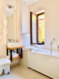 a bathroom with a tub and a sink and a toilet at Arce Boutique in Braşov