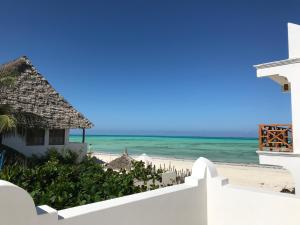 a view of the beach from the balcony of a resort at Mwendawima Beach Villa in Jambiani