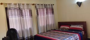 a bedroom with a bed with curtains and a bed sidx sidx sidx at ADISSA in Cotonou