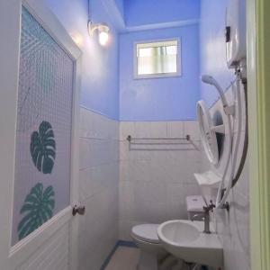 a bathroom with a white toilet and a sink at Mountain View Hostel - Krabi in Krabi