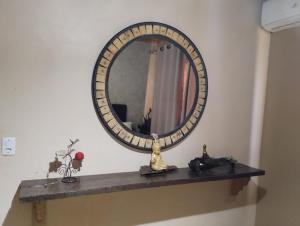 a mirror on top of a shelf in a room at Pousada Avambaé in São Miguel das Missões