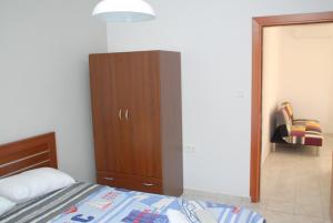 a bedroom with a bed and a wooden cabinet at Istira in Possidi