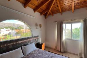 Postel nebo postele na pokoji v ubytování Cosquín Casa a metros del río con pileta - Hasta 12 personas + 60 fotografií