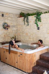 two people in a jacuzzi tub in a building at Apanemia Inn Studio in Lofou