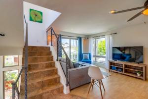 a living room with a staircase and a tv at Beach Oasis - Rooftop, Steps2Sand and Water Views in San Diego