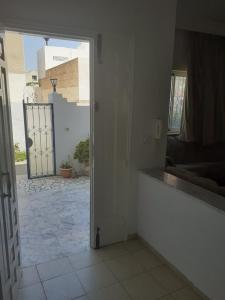 a room with a door open to a courtyard at Villa S+3 Bien Equipée à 200m de la plage in Hammamet