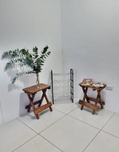 two tables in a room with a plant on it at Apartamento tipo Loft in Guatemala