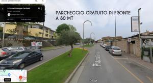a street with cars parked on the side of the road at Foresteria Opera in Rovato