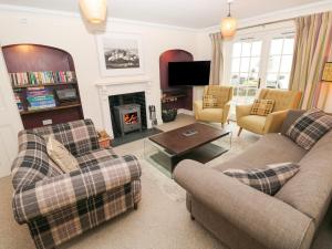 a living room with two couches and a fireplace at The Old Boathouse in Haverfordwest