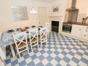 a kitchen with a blue and white checkered floor at The Old Boathouse in Haverfordwest
