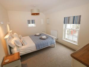 a bedroom with a bed and a window at The Old Boathouse in Haverfordwest