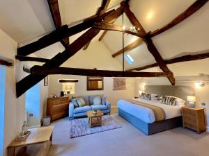 a large bedroom with a bed and a couch at Castle Cottage Inn in Harlech
