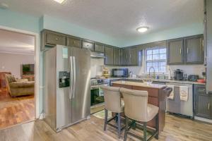 a kitchen with a refrigerator and a table and chairs at Charming Tennessee Retreat with Fireplace and Grill! in Jackson
