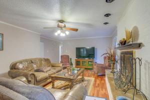 a living room with two couches and a tv at Charming Tennessee Retreat with Fireplace and Grill! in Jackson