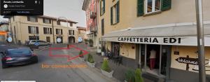 a car driving down a street next to a building at Foresteria Opera B&b in Rovato