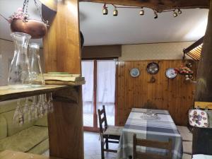 a kitchen with a table and a dining room at Casa di Lucy in Frabosa Soprana