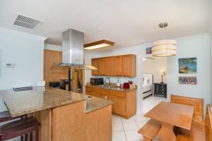 a kitchen with wooden cabinets and a counter top at Oceans 13 Unit A in Saint Augustine Beach