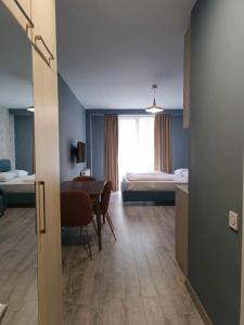 a room with a bedroom with a table and a bed at new Gudauri 214 in Gudauri