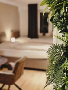 1 dormitorio con 1 cama y una planta verde en Modern & Comfortable Apartment Stuttgart - Netflix - 4K TV - waipu en Korntal-Münchingen