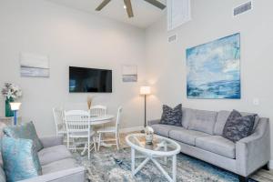 a living room with a couch and a table at Oceans 13 Condo D in Saint Augustine Beach