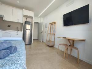 a kitchen with a bed and a desk in a room at Apartamentos Bello Lanzarote in Arrecife
